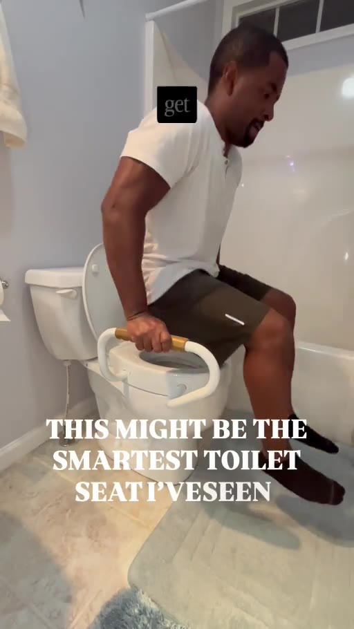 Dr. James Montgomery demonstrating a raised toilet seat with handles